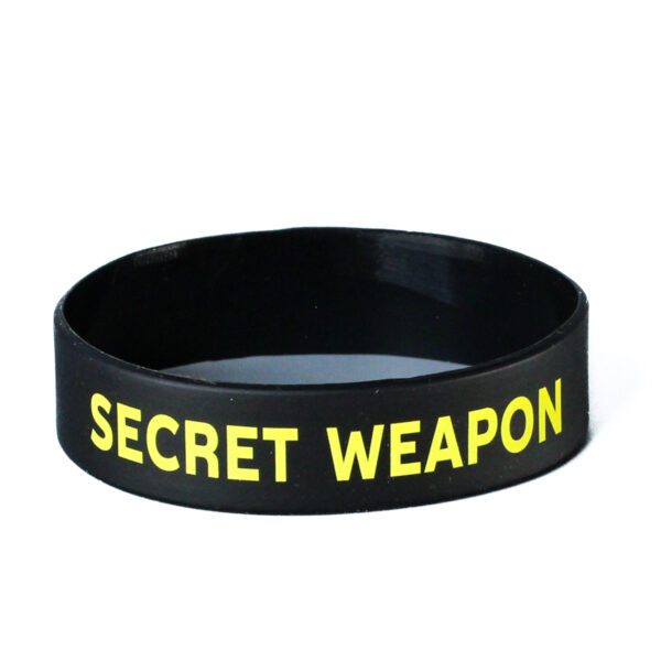 A black and yellow bracelet with the words " secret weapon ".