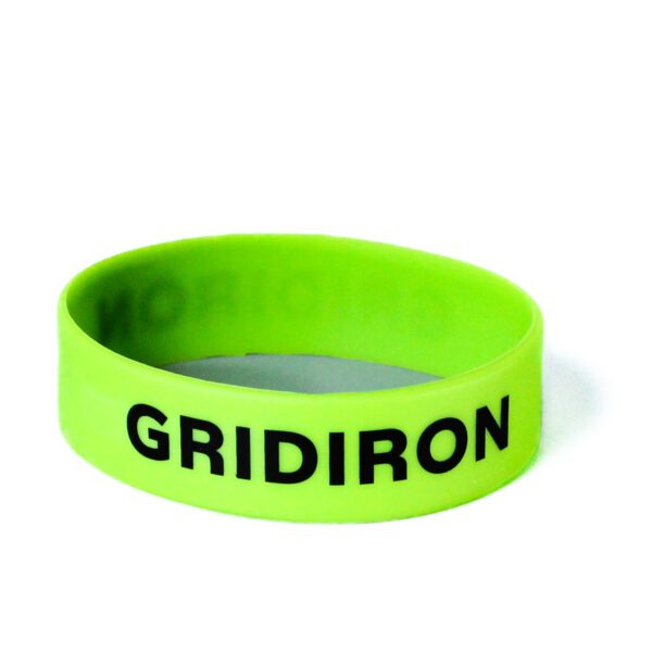 A neon green wristband with the word " gridiron " written on it.