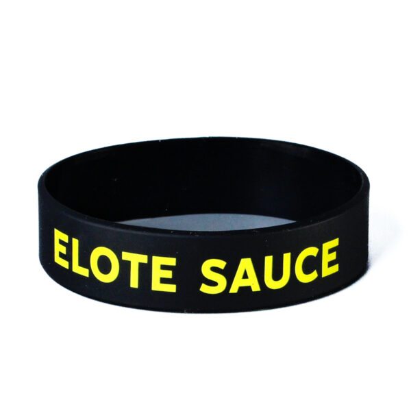 A black and yellow bracelet with the words " elote sauce ".