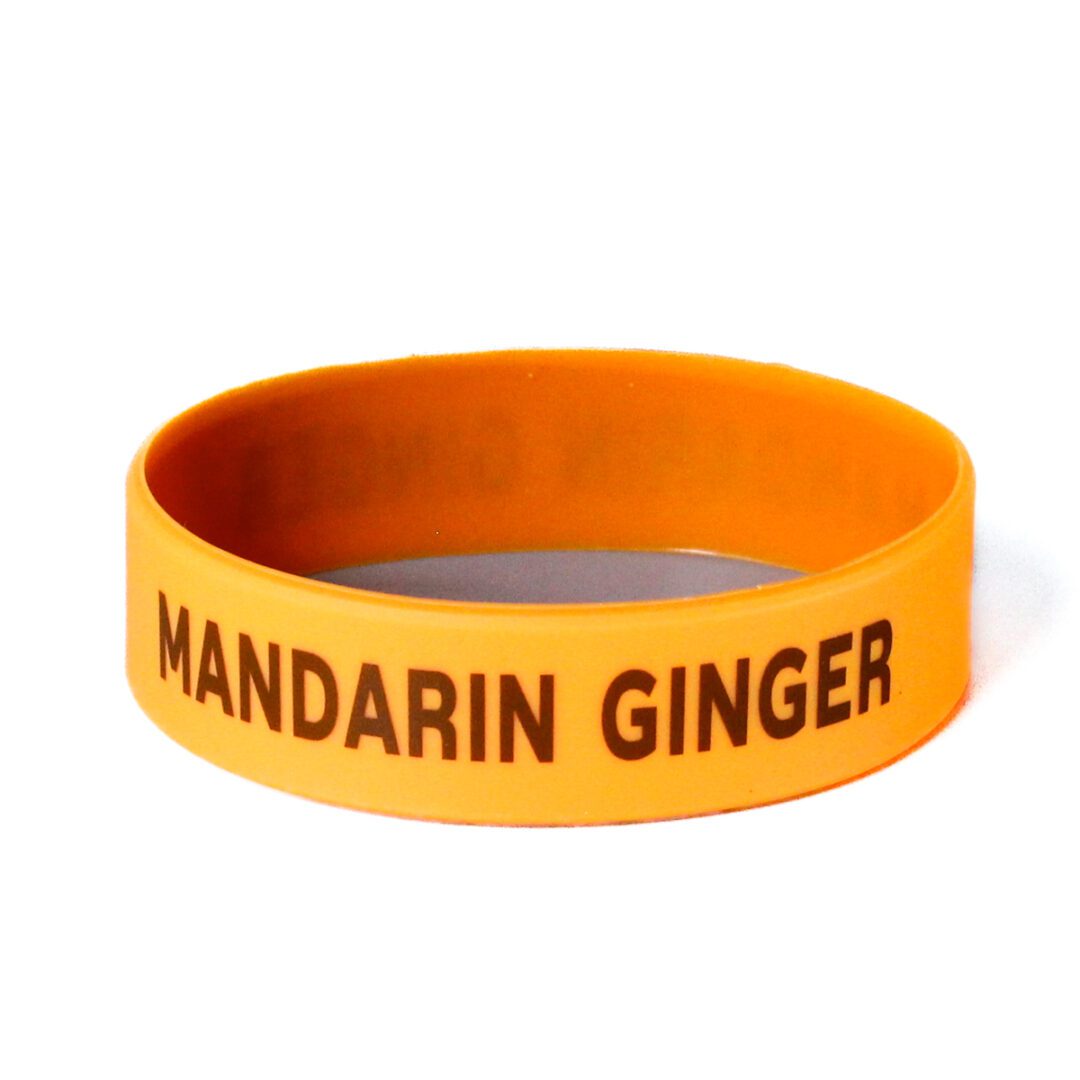 A yellow bracelet with the words mandarin ginger on it.