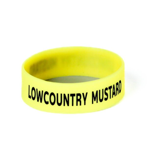 A yellow wristband with the words " lowcountry mustard ".