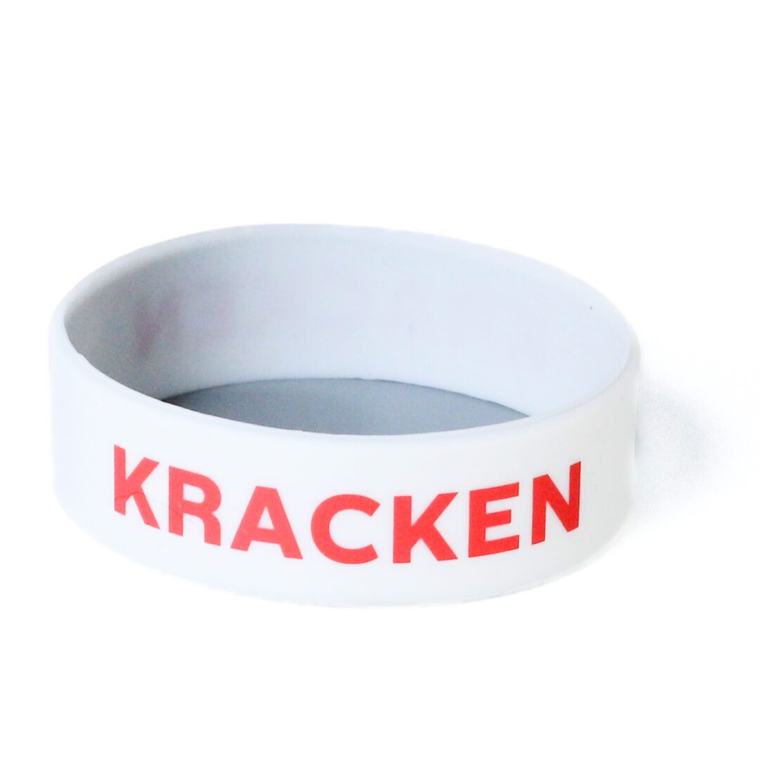 A white wristband with the word " kracken " written on it.