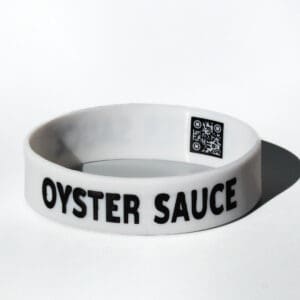 White bracelet labeled "Oyster Sauce" with QR.