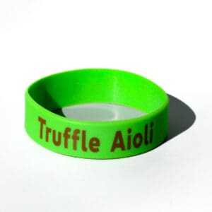 Green wristband with "Truffle Aioli" text.