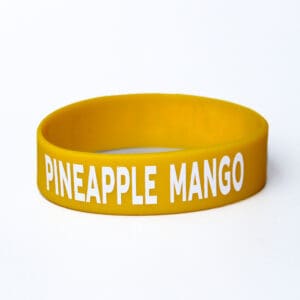 Yellow wristband with "Pineapple Mango" text.