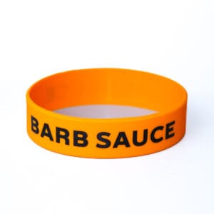 Orange wristband with "BARB SAUCE" text.