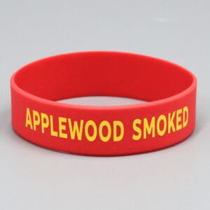 Red wristband with "APPLEWOOD SMOKED" text.