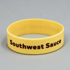 Yellow wristband with "Southwest Sauce" text.