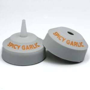 Spicy garlic bottle caps, white and orange.