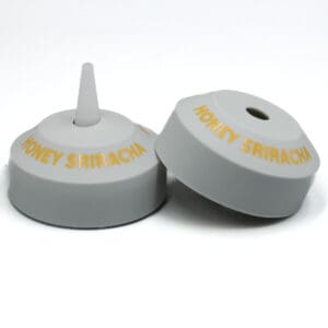 Honey Sriracha bottle caps on display.