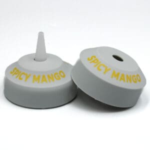 Spicy Mango bottle caps on white background.