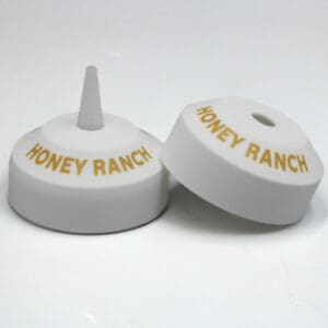 Honey Ranch bottle caps on white background.