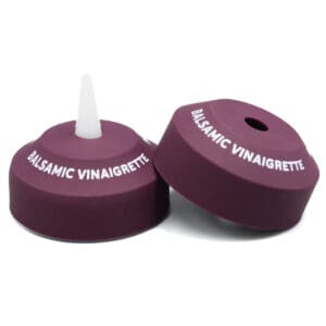 Balsamic vinaigrette caps on white background.