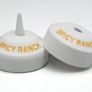 Spicy Ranch bottle caps on white background.