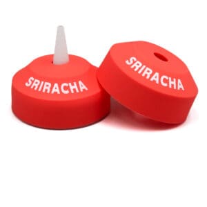 Red Sriracha bottle caps on display.