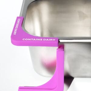 Container with "Contains Dairy" label, pink clip.