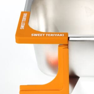 Orange Sweet Teriyaki container clip on sink.