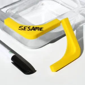 Yellow corner protectors on a glass container.