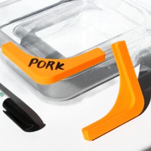 Orange food divider labeled "Pork" on container.