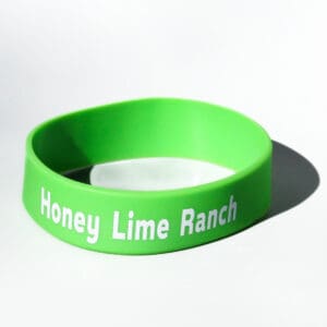 Green bracelet with "Honey Lime Ranch" text.