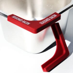 Red bacon-themed clip on metal container.