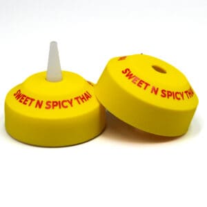 Yellow bottle caps labeled "Sweet N Spicy Thai".