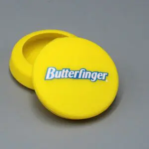 Yellow Butterfinger-branded container on gray background.