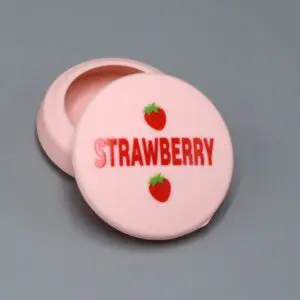 Pink container with "Strawberry" label and strawberries.