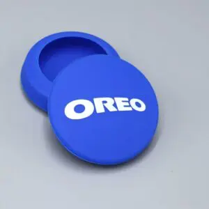 Blue Oreo-branded silicone container on gray background.