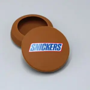 Brown Snickers-branded circular container, lid open.