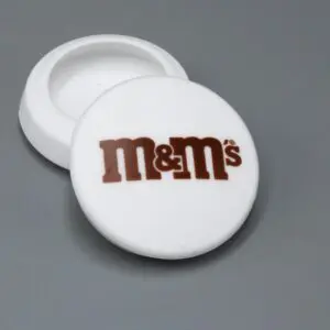 White M&M's container with open lid.
