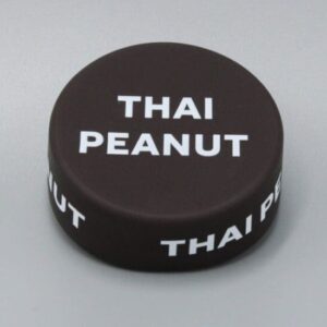 Thai peanut sauce jar lid on surface.