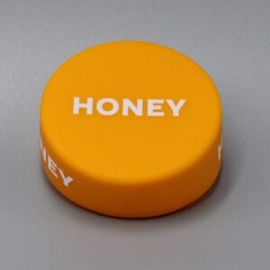 Orange puck with "HONEY" text on top.