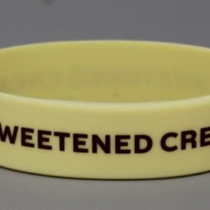 Yellow wristband with "SWEETENED CREAM" text.