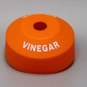 Orange vinegar bottle cap with hole.