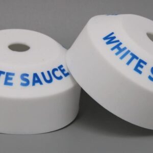White plastic objects labeled "White Sauce".