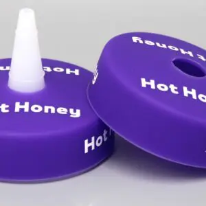Purple "Hot Honey" bottle caps on display.