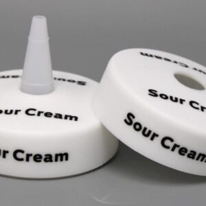Sour cream squeeze bottle caps on display.