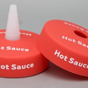 Red hot sauce bottle caps with text.