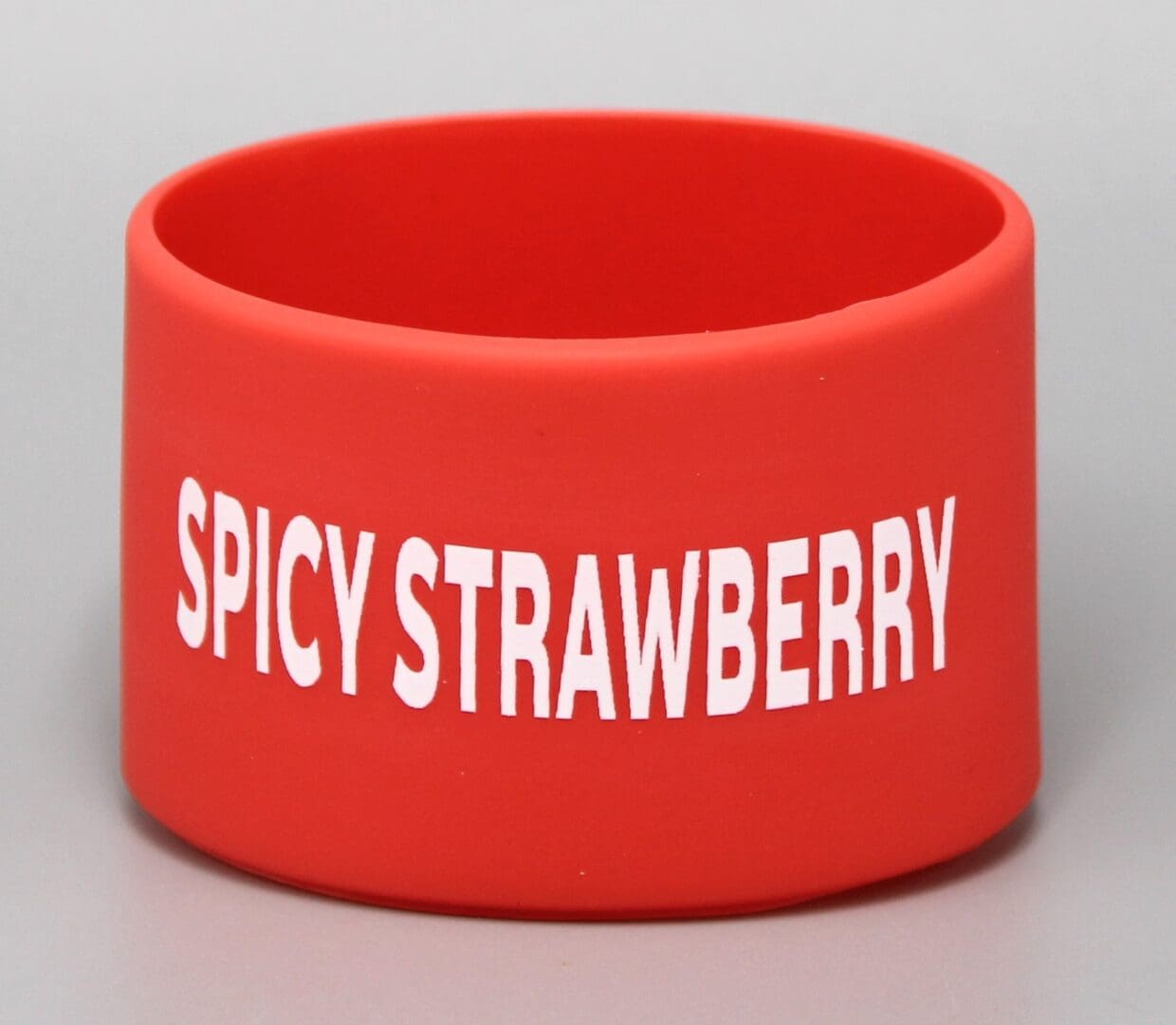 Red wristband with "Spicy Strawberry" text.