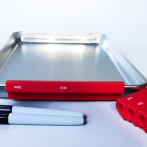 Baking tray with red labels and markers.