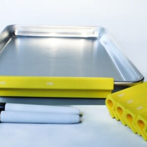Metal tray with markers and yellow clips.