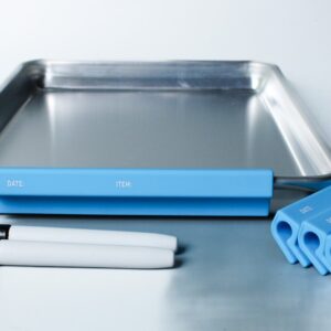 Metal tray with blue labels and markers.