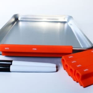 Baking tray with labels and markers.