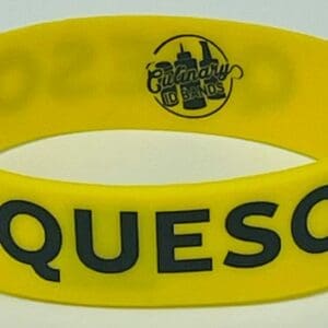 Yellow silicone wristband reading QUESO