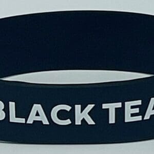 Black silicone wristband reading "BLACK TEA