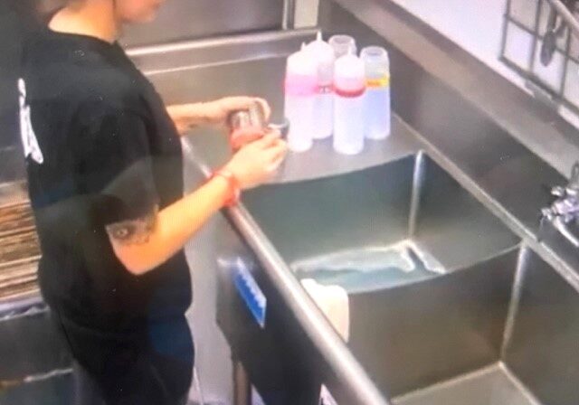 A person standing in front of a sink.